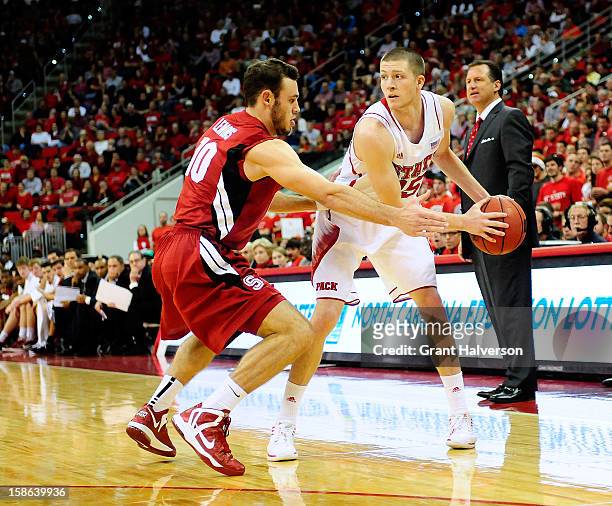 Robbie Lemons of the Stanford Cardinal defends Scott Wood of the North Carolina State Wolfpack during play at PNC Arena on December 18, 2012 in...