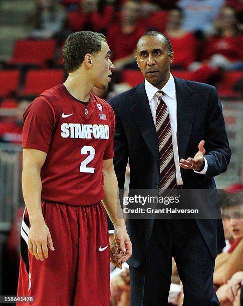 Coach Johnny Dawkins confers with Aaron Bright of the Stanford Cardinal against the North Carolina State Wolfpack at PNC Arena on December 18, 2012...