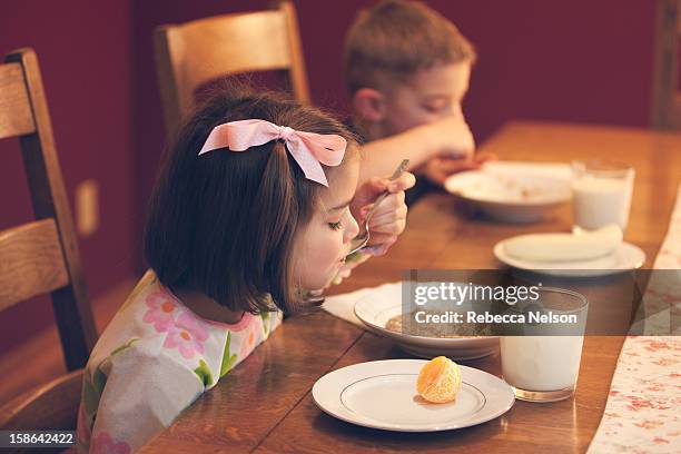 brother and sister enjoying an oatmeal breakfast - hair bow imagens e fotografias de stock