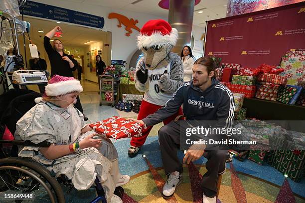 Lou Amundson and Mascot Crunch of the Minnesota Timberwolves distribute holiday gifts collected through the Minnesota Timberwolves Fastbreak...