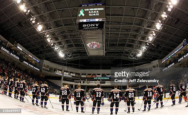 Members of the Bridgeport Sound Tigers wear jerseys emblazoned with the names of Sandy Hook Elementary shooting victims during a moment of silence...