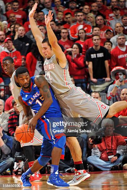 Aaron Craft of the Ohio State Buckeyes guards Elijah Johnson of the Kansas Jayhawks in the second half on December 22, 2012 at Value City Arena in...