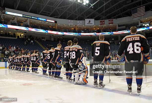 Members of the Bridgeport Sound Tigers wear jerseys with the names of Sandy Hook Elementary School shooting victims as they stand for the National...