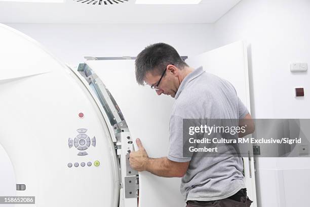 worker examining medical equipment - medical technical equipment stock pictures, royalty-free photos & images
