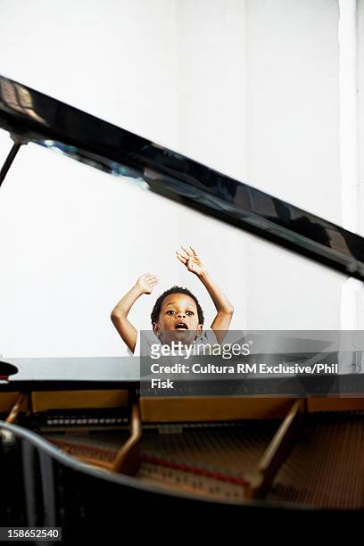 boy playing grand piano - grand piano film stock-fotos und bilder