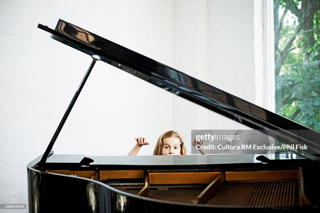 Girl playing grand piano