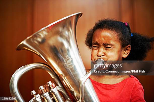 girl playing tuba - blaasinstrument stockfoto's en -beelden