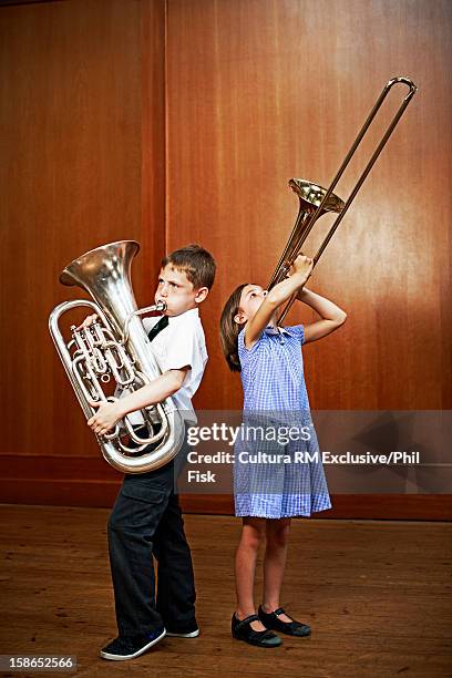 children playing brass instruments - tube foto e immagini stock