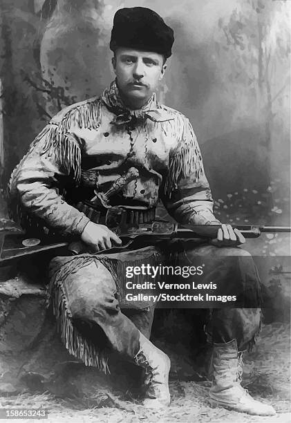 digitally restored vector portrait of a young theodore roosevelt with his high-decorated deer-skin hunting suit, and carved tiffany hunting knife and rifle. circa 1885. - theodore roosevelt stock-fotos und bilder