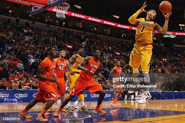 Phil Pressey of the Missouri Tigers pulls down a rebound against Brandon Paul and Nnanna Egwu both of the Illinois Fighting Illini during the Bud...