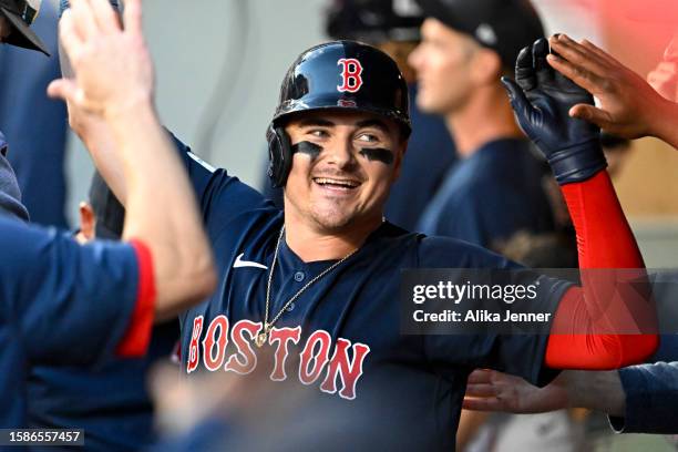 Reese McGuire of the Boston Red Sox celebrates with teammates after hitting a home run during the sixth inning against the Seattle Mariners at...