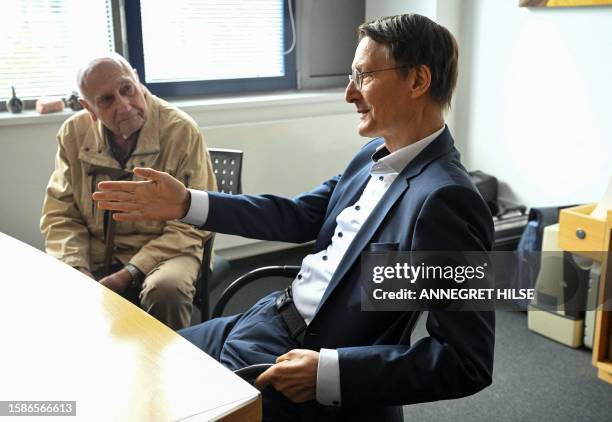 German Health Minister Karl Lauterbach sits next to patient Peter Jordan as he presents the new process for issuing an e-prescription at a joint...