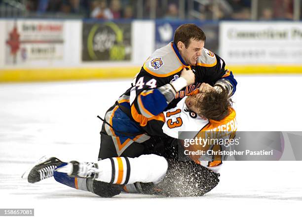 Brett Gallant of the Bridgeport Sound Tigers and Zack FitzGerald of the Adirondack Phantoms fight during an American Hockey League game on December...