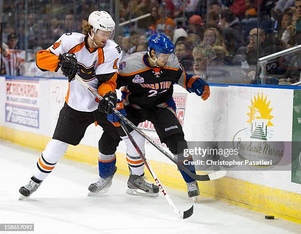 Sean Couturier of the Adirondack Phantoms and David Ullstrom of the Bridgeport Sound Tigers play for possession of the puck during an American Hockey...