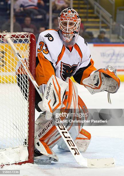 Scott Munroe of the Adirondack Phantoms looks on as he tends goal during an American Hockey League game against the Bridgeport Sound Tigers on...