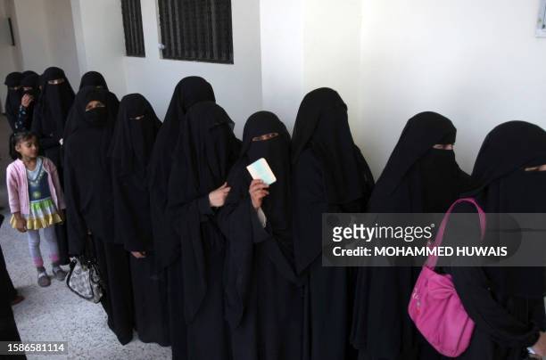 Yemeni women line-up outside a polling station to cast their vote in the presidential election in Sanaa on February 21, 2012 that brings an end to...