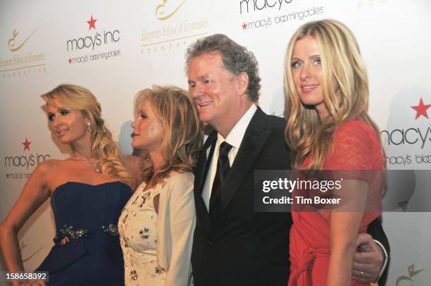 American hotelier Richard Hilton poses with his wife, Kathy , and socialite daughters, Paris and Nicky as they attend a dinner for the European...