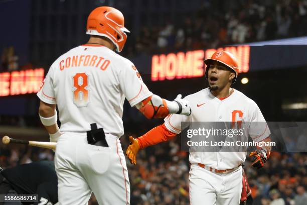 LaMonte Wade Jr. #31 of the San Francisco Giants celebrates with Michael Conforto after hitting a solo home run in the bottom of the seventh inning...