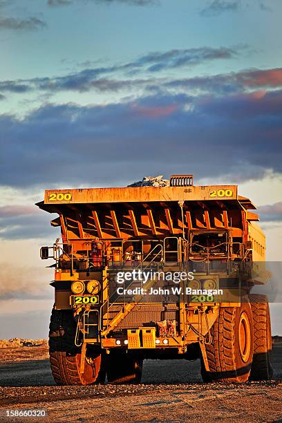 dump truck dumping rocks at a gold mine - banagan dumper truck stock pictures, royalty-free photos & images