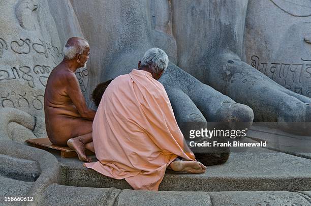 Digambara-Monk, always without clothes and his student resting and praying at the feet of the gigantic staue of Gomateshwara in Sravanabelagola..