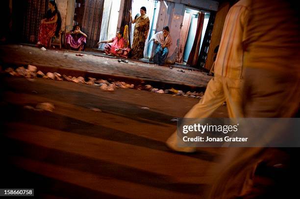Women wait for customers outside a brothel in Kamathipura. The price of sex has gone up since the British established the notorious Kamathipura as a...