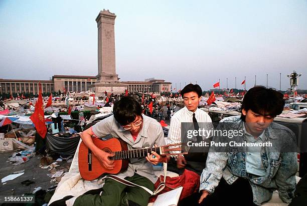 Peaceful musical protest - A man plays a guitar in Tiananmen Square. Pro-democracy demonstrators and protestors filled the square for weeks prior to...