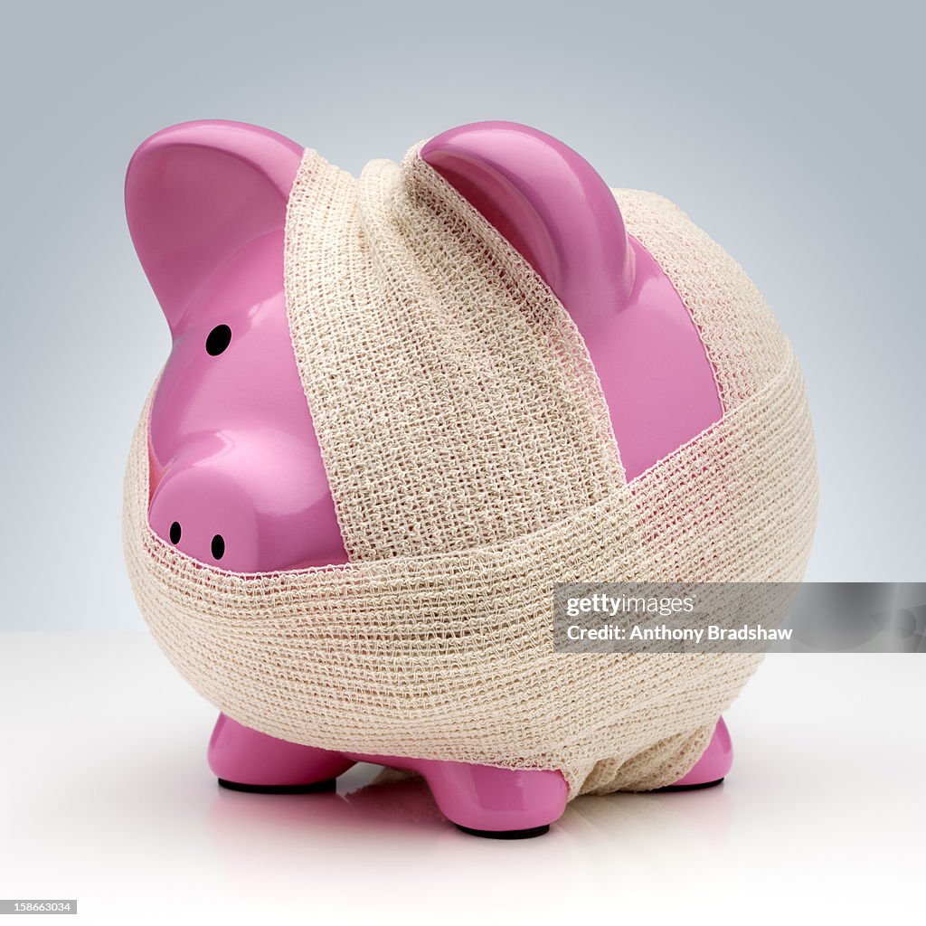 Bandaged pink piggy bank