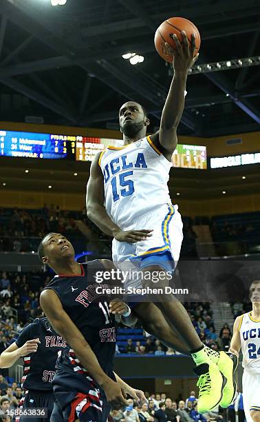 Shabazz Muhammad of the UCLA Bruins goes up for a shot over Aaron Anderson of the Fresno State Bulldogs at Pauley Pavilion on December 22, 2012 in...