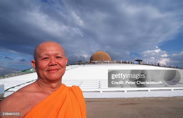 Vice Abbot Dattajeevo Bhikku in front of the huge Stupa, the Maha Dhammakaya Cetiya. The golden dome of the Stupa at Wat Dhammakaya is 32 meters high...