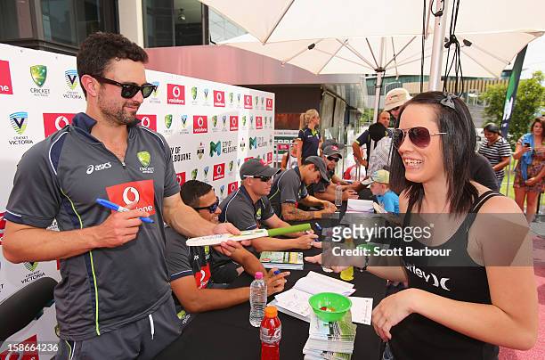 Ed Cowan of Australia signs autographs for fans during an Australian Test team appearance at Queensbridge Square on December 23, 2012 in Melbourne,...
