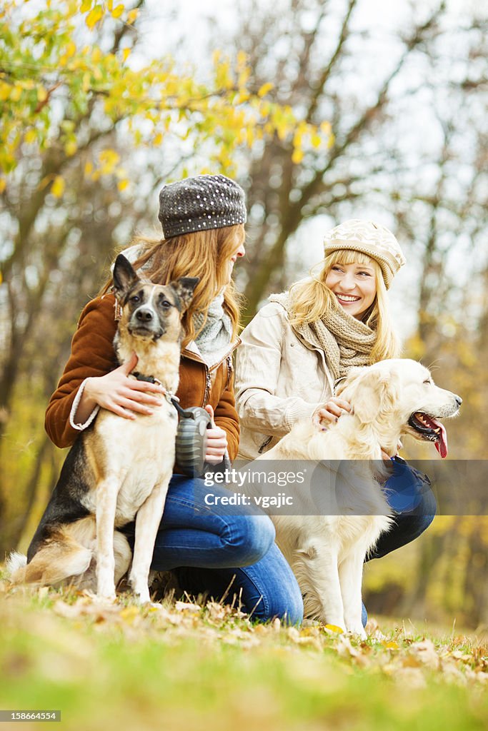 Cheerful Young Woman With Dogs outdoors.