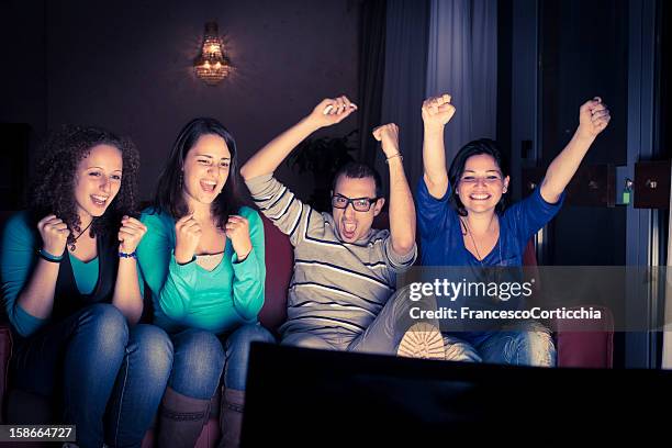 four teenager watching tv - friends tv show stock pictures, royalty-free photos & images