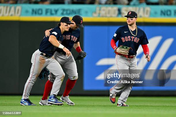 Jarren Duran, Adam Duvall, and Alex Verdugo of the Boston Red Sox celebrate after the game against the Seattle Mariners at T-Mobile Park on August...