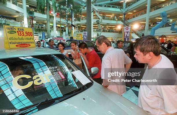 Potential customers browse through the main lobby of Seacon Square, which is one of Bangkok's largest shopping malls. The main lobby area is filled...