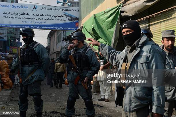 Afghan police personnel cordon off a street after a huge fire swept through a market in Kabul on December 23, 2012. A huge fire swept through a...