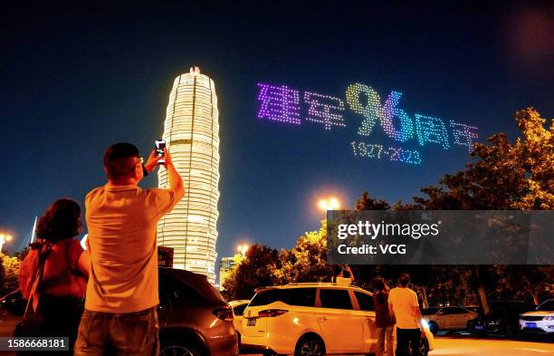Drones fly in formation to form different patterns over Ruyi Lake square in celebration of China's Army Day on August 1, 2023 in Zhengzhou, Henan...