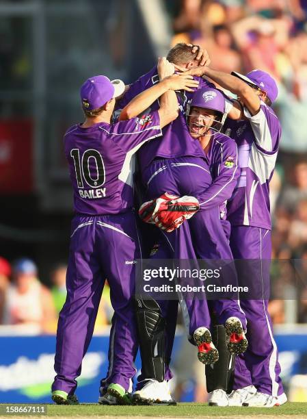 Xavier Doherty of the Hurricanes celebrates with team mates after taking a hat trick during the Big Bash League match between the Hobart Hurricanes...