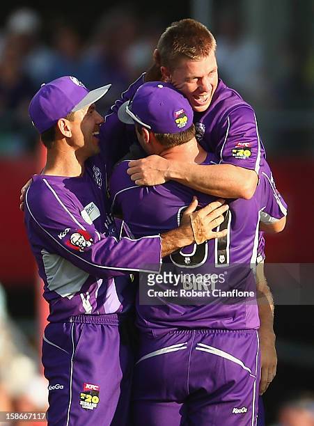 Xavier Doherty of the Hurricanes celebrates with team mates after taking a hat trick during the Big Bash League match between the Hobart Hurricanes...
