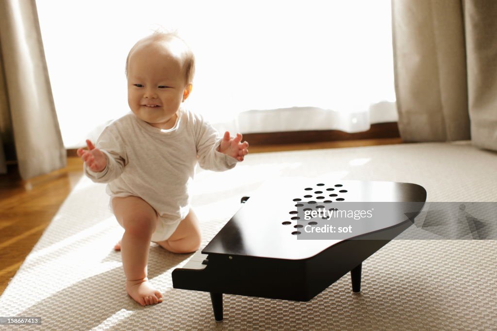 Baby boy playing small piano