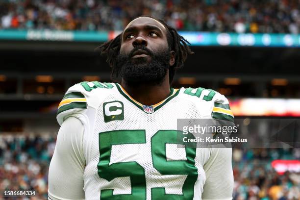 De'Vondre Campbell of the Green Bay Packers stands on the sidelines during the national anthem prior to an NFL football game against the Miami...