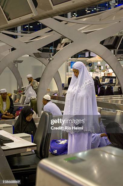 Muslim woman from the south of Thailand prays in the terminal building of Thailand's Suvarnabhumi international airport. Hundreds of Muslims trying...