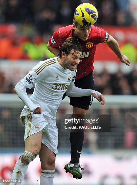 Manchester United's Serbian defender Nemanja Vidic vies with Swansea's Miguel Michu during the English Premier League football match between Swansea...