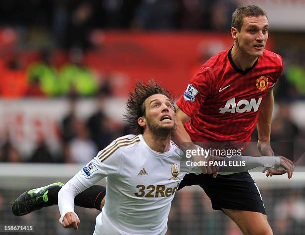 Manchester United's Serbian defender Nemanja Vidic vies with Swansea's Miguel Michu during the English Premier League football match between Swansea...