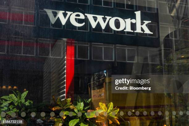 Logo near an entrance to a WeWork Inc. Co-working office near Waterloo railway station in London, UK, on Wednesday, Aug. 9, 2023. The New York-based...