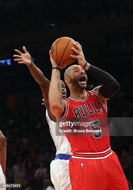 Carlos Boozer of the Chicago Bulls grabs a rebound against the New York Knicks at Madison Square Garden on December 21, 2012 in New York City. NOTE...