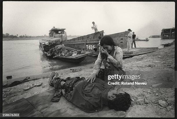 The bodies of government soldiers killed in an operation to the south of Phnom Penh are brought back to the capital by navy boats. Grieving families...