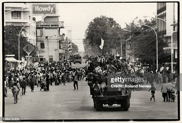 The fall of Phnom Penh. A convoy of trucks and armoured personnel carriers commandered by the victorious Khmer Rouge drives through the city center...