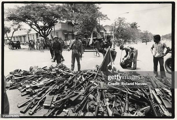 The fall of Phnom Penh on April 17, 1975. Government soldiers and civilians surrender their arms under the watchful eyes of the Khmer Rouge at a...