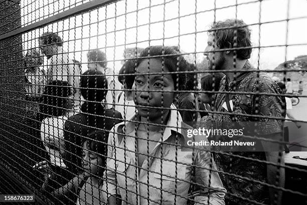 The Fall of Phnom Penh to the Khmer Rouge on April 17, 1975. At the gate at the French Embassy, consular authorities are trying to accommodate the...