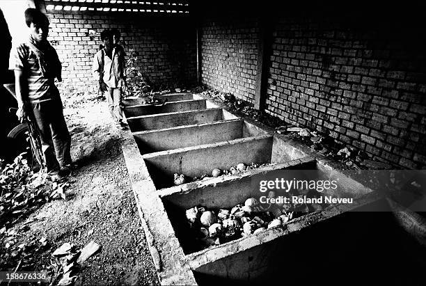 Soldier is standing by a mss grave of victims of the Pol Pot regime near the hills of the former Cambodian capital of Oudong, just 40 km North of...